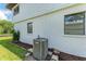 Exterior side of the home with a modern AC unit and well-maintained landscaping at 5111 Coral Blvd, Bradenton, FL 34210