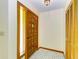 Inviting foyer featuring a wood door with decorative glass, tiled flooring, and closet space at 5111 Coral Blvd, Bradenton, FL 34210