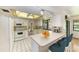 Bright kitchen featuring all-white appliances, tile flooring, and a breakfast bar with seating at 5111 Coral Blvd, Bradenton, FL 34210