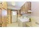 Laundry room with a utility sink, washer, dryer, and an exterior door at 5111 Coral Blvd, Bradenton, FL 34210
