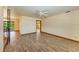 Spacious living area with wood-look floors, ceiling fan, and views into the backyard at 5111 Coral Blvd, Bradenton, FL 34210