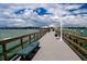 Scenic pier view with wooden benches stretching over clear waters to a distant horizon, great for tranquil walks at 5111 Coral Blvd, Bradenton, FL 34210