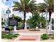 Charming public square with lush landscaping, towering palm trees, and classical sculptures, offering a serene ambiance at 5111 Coral Blvd, Bradenton, FL 34210