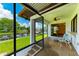Screened porch featuring waterfront views and outdoor seating at 5111 Coral Blvd, Bradenton, FL 34210
