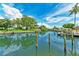 Scenic view of canal showcasing lush landscaping, blue water, and docks with palm trees at 5111 Coral Blvd, Bradenton, FL 34210