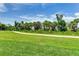 Landscaped backyard with a pathway and lush greenery at 17445 Opal Sand Dr # 104, Venice, FL 34293