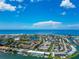 Aerial view of coastal community, with ocean, buildings, and waterways at 12405 3Rd E St # 206, Treasure Island, FL 33706