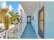 View of condo hallway with light blue walls and white railing at 12405 3Rd E St # 206, Treasure Island, FL 33706
