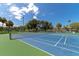 Two well-maintained tennis courts with surrounding landscape at 12405 3Rd E St # 206, Treasure Island, FL 33706