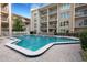 Inviting community pool with surrounding patio furniture at 845 Benjamin Franklin Dr # 202, Sarasota, FL 34236