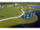 Aerial view of a community with playground, lake, and clubhouse at 10145 Spruce River Way, Parrish, FL 34219