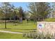 Outdoor fitness area with equipment and Neal Land Neighborhoods sign at 10145 Spruce River Way, Parrish, FL 34219