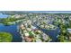 Wide aerial showcasing waterfront home, private pool, and lush landscaping at 5319 Bimini Dr, Bradenton, FL 34210