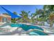 Relaxing pool and spa with canal views and blue shade sail at 5319 Bimini Dr, Bradenton, FL 34210