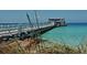 Long pier extending over blue water with people walking at 5319 Bimini Dr, Bradenton, FL 34210