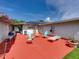 Red patio with seating, grill, and view of house exterior at 1499 17Th W St, Palmetto, FL 34221