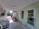 Covered back porch with seating and backyard access at 1499 17Th W St, Palmetto, FL 34221