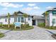Inviting single Gathering home exterior with landscaping and paver driveway at 6227 Dry Tortugas Dr, Sarasota, FL 34241