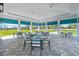 Covered outdoor patio area with tables and chairs at 6227 Dry Tortugas Dr, Sarasota, FL 34241