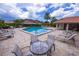 Community pool with patio furniture for relaxing at 3851 Wilshire Dr # 9, Sarasota, FL 34238