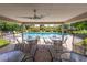 Relaxing pool area with tables and chairs under covered patio at 3851 Wilshire Dr # 9, Sarasota, FL 34238