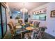 Formal dining room featuring a glass-top table and floral chairs at 3851 Wilshire Dr # 9, Sarasota, FL 34238