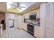 Clean kitchen with white cabinets and built in microwave at 3851 Wilshire Dr # 9, Sarasota, FL 34238