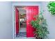 Inviting entryway with red door and view to living room at 3851 Wilshire Dr # 9, Sarasota, FL 34238