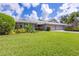 Front view of home with lush lawn and landscaping at 3851 Wilshire Dr # 9, Sarasota, FL 34238