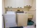 Laundry room with washer, dryer, cabinets and a sink at 3851 Wilshire Dr # 9, Sarasota, FL 34238