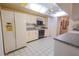 Galley kitchen featuring white cabinetry and granite countertops at 3851 Wilshire Dr # 9, Sarasota, FL 34238