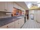 Bright kitchen offering ample counter space and view to dining area at 3851 Wilshire Dr # 9, Sarasota, FL 34238