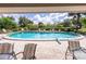 Community pool with surrounding patio furniture at 3851 Wilshire Dr # 9, Sarasota, FL 34238