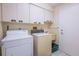 Bright laundry room, featuring washer, dryer, cabinets, and utility sink at 3851 Wilshire Dr # 9, Sarasota, FL 34238