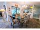 Elegant dining room with a glass-top table and chandelier at 3851 Wilshire Dr # 9, Sarasota, FL 34238
