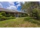 Landscaped backyard with lush green grass and mature trees at 3851 Wilshire Dr # 9, Sarasota, FL 34238