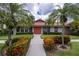 Community clubhouse with attractive landscaping and walkway at 3851 Wilshire Dr # 9, Sarasota, FL 34238