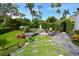 Landscaped backyard with stone patio and lush gardens at 2107 89Th St Nw, Bradenton, FL 34209