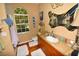 Bathroom with wood cabinets, large window, and updated fixtures at 2107 89Th St Nw, Bradenton, FL 34209