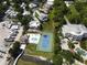 Aerial view of waterfront property with pool, tennis court, and boat slips at 2107 89Th St Nw, Bradenton, FL 34209