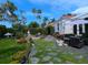 Relaxing patio area with seating, fire pit, and lush tropical landscaping at 2107 89Th St Nw, Bradenton, FL 34209