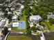 Aerial showing large home, pool, tennis court, and waterfront access at 2107 89Th St Nw, Bradenton, FL 34209