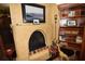 Living room with a beautiful fireplace and built-in wooden shelving at 2107 89Th St Nw, Bradenton, FL 34209