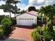 Property features brick driveway, white house, and lush landscaping at 2107 89Th St Nw, Bradenton, FL 34209