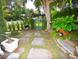Secluded backyard with stone patio and green gate at 2107 89Th St Nw, Bradenton, FL 34209