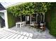 Covered patio with dining table and comfortable seating area, surrounded by greenery at 2107 89Th St Nw, Bradenton, FL 34209