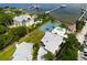 Aerial view of waterfront property with tennis court and private pool at 2107 89Th St Nw, Bradenton, FL 34209