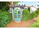 Charming entrance with a unique gate and lush landscaping at 2107 89Th St Nw, Bradenton, FL 34209