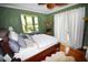 Spacious bedroom with hardwood floors, large windows, and a comfy bed at 2107 89Th St Nw, Bradenton, FL 34209
