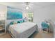 Spacious bedroom with ceiling fan, large bed and ocean-themed decor at 8809 Manor Loop # 102, Lakewood Ranch, FL 34202